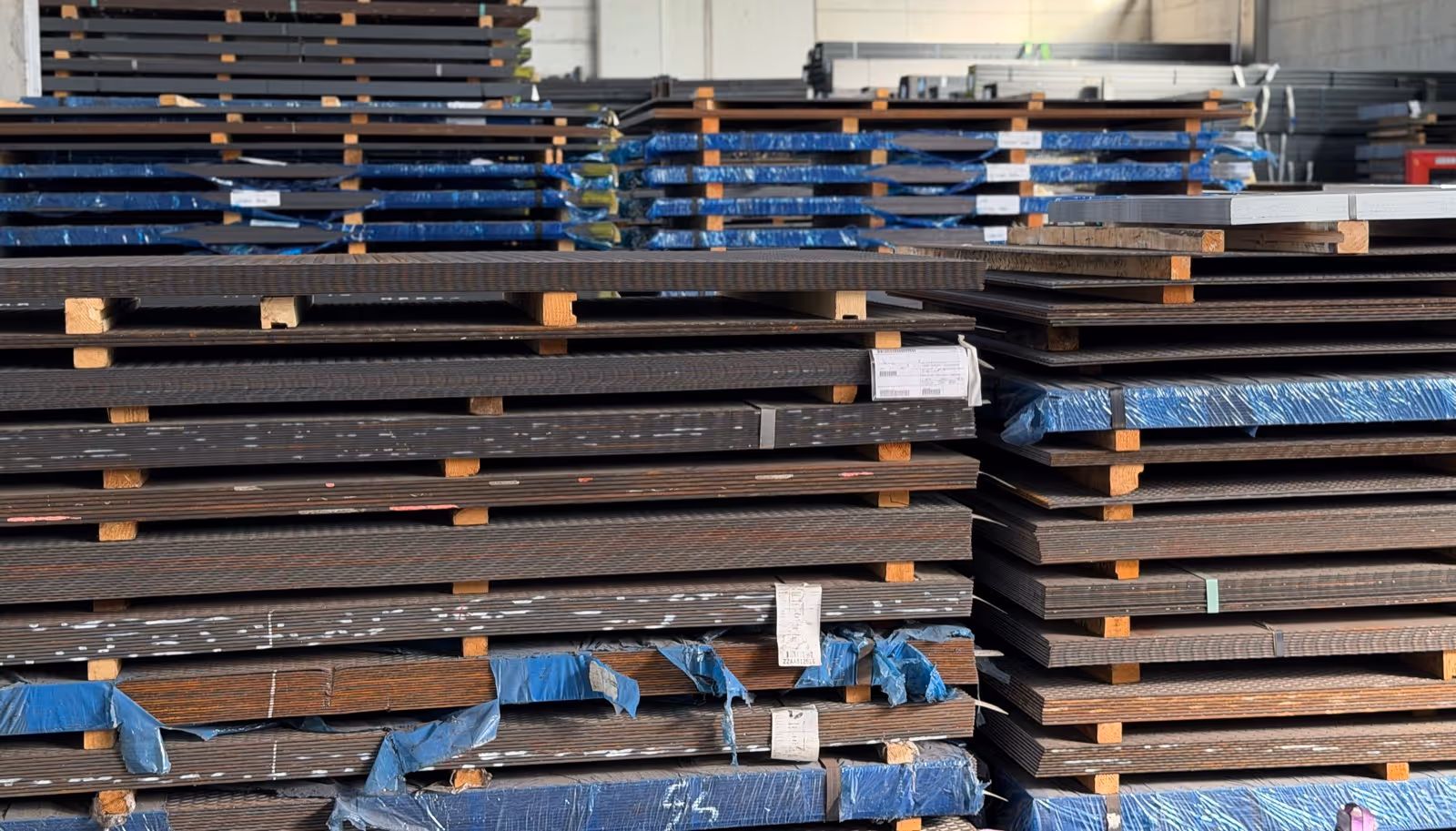 Sheets from coils — packs on pallets in the warehouse